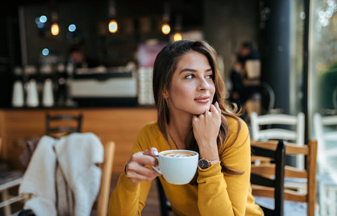 woman drinking coffee in a cafe