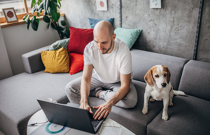 man-working-laptop-dog