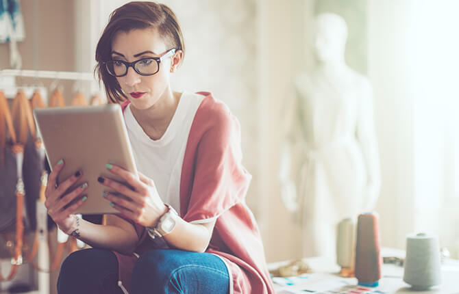 young woman reviewing finances tablet