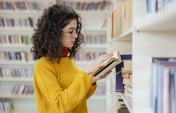 Woman looking at a book in the library