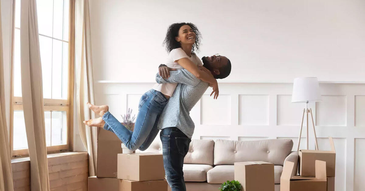 couple new home embracing