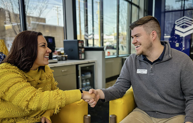 Employee and customer shaking hands