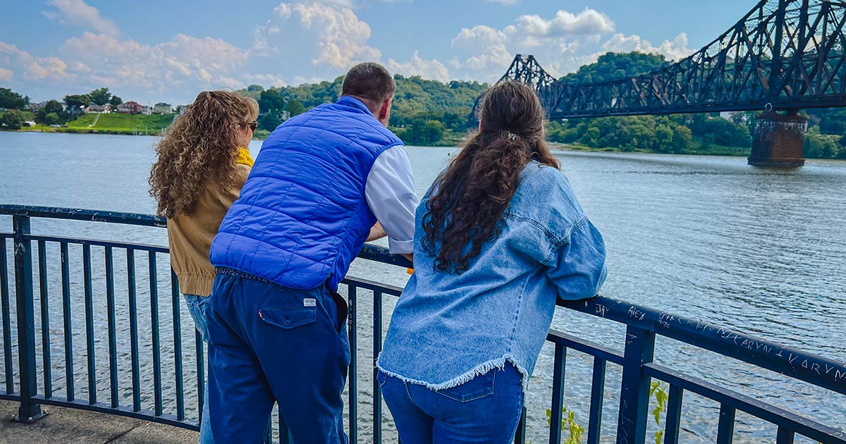 friends on bridge near river