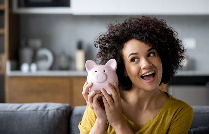 woman holding piggy bank smiling