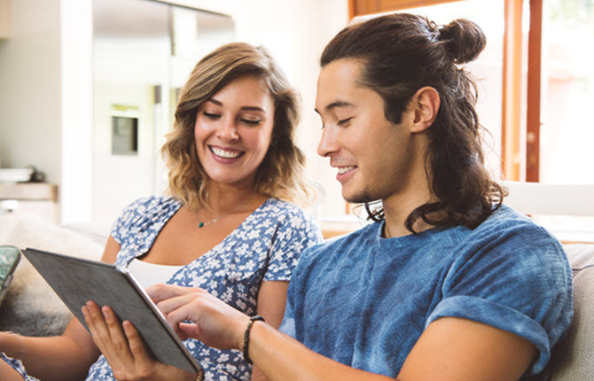 Couple looking at their tablet