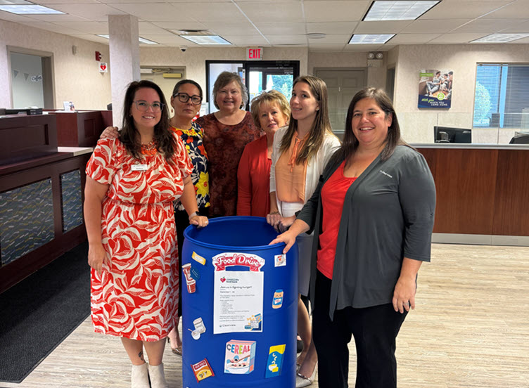 volunteers standing at food collection bin
