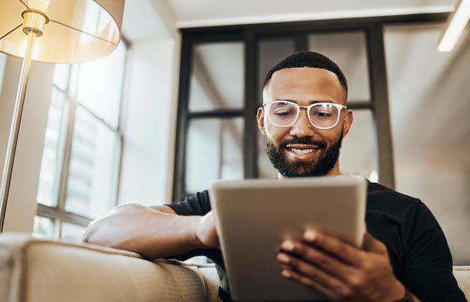 Man with glasses looking at iPad
