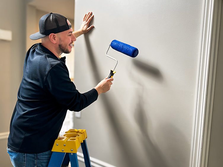 man painting walls
