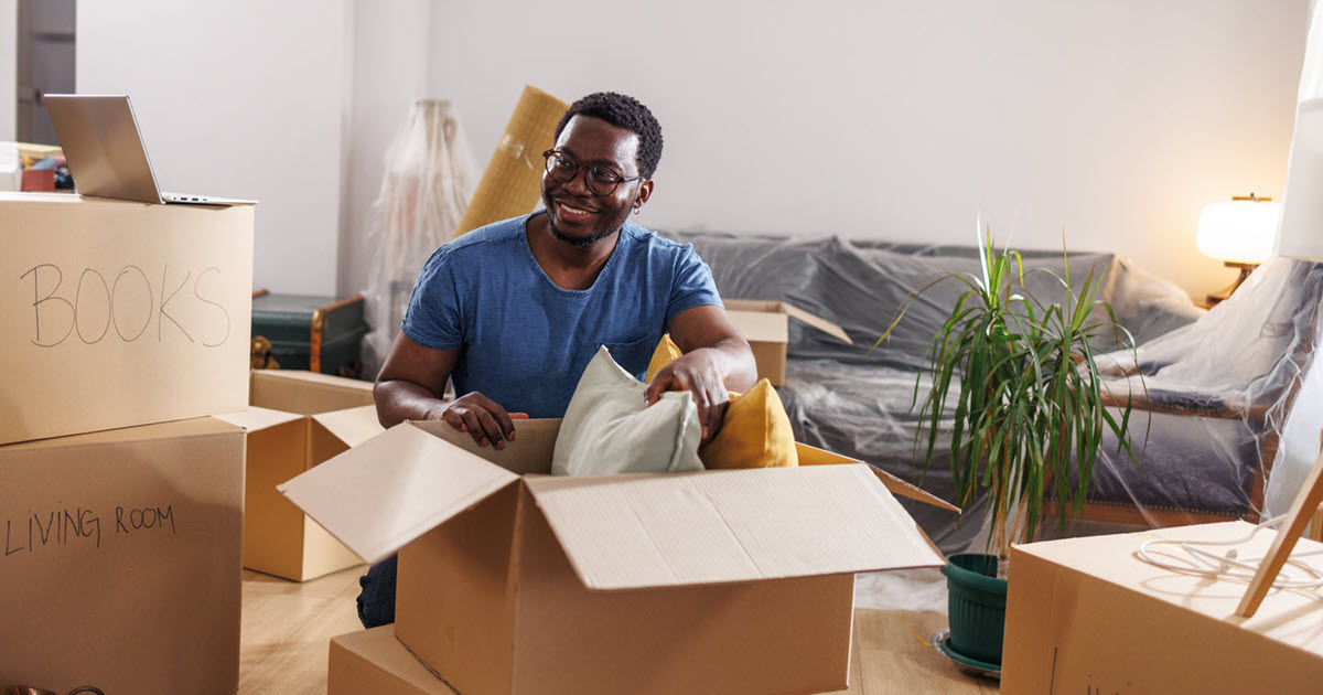 man boxes new home moving